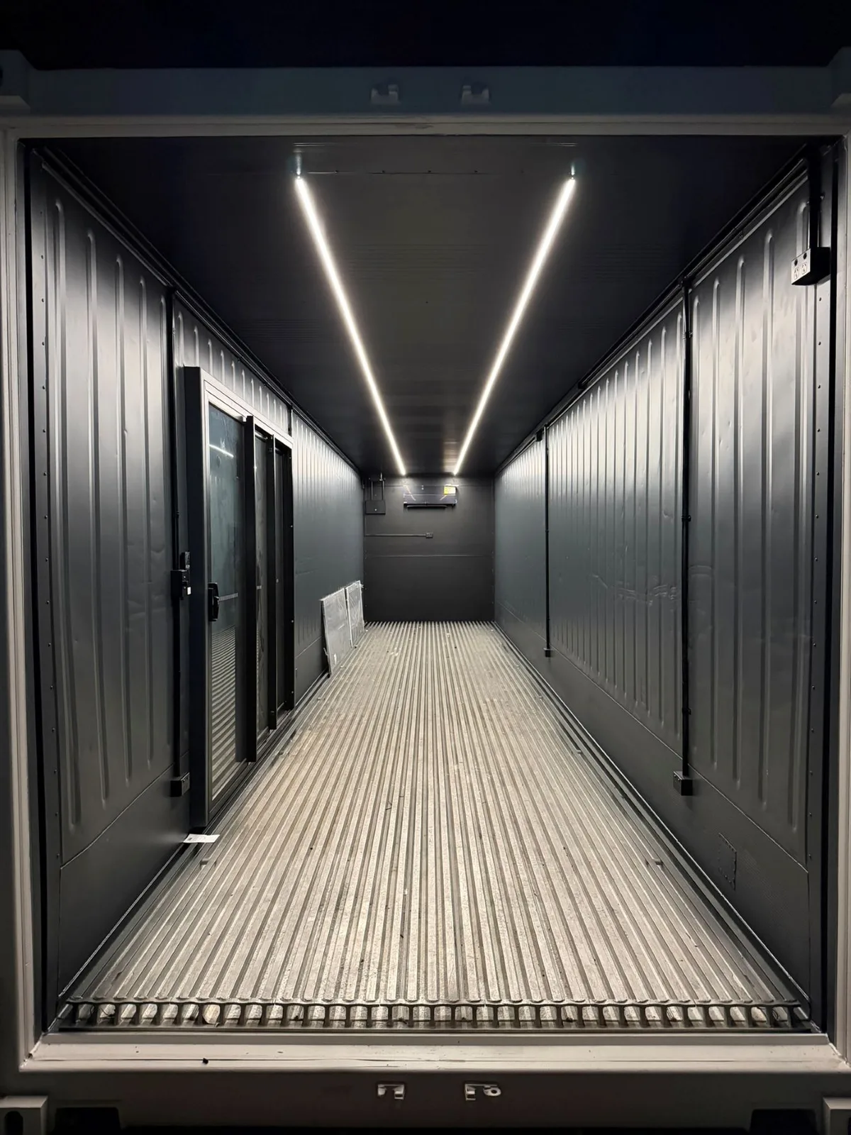 Gym fit-out, linear LED on a black ceiling