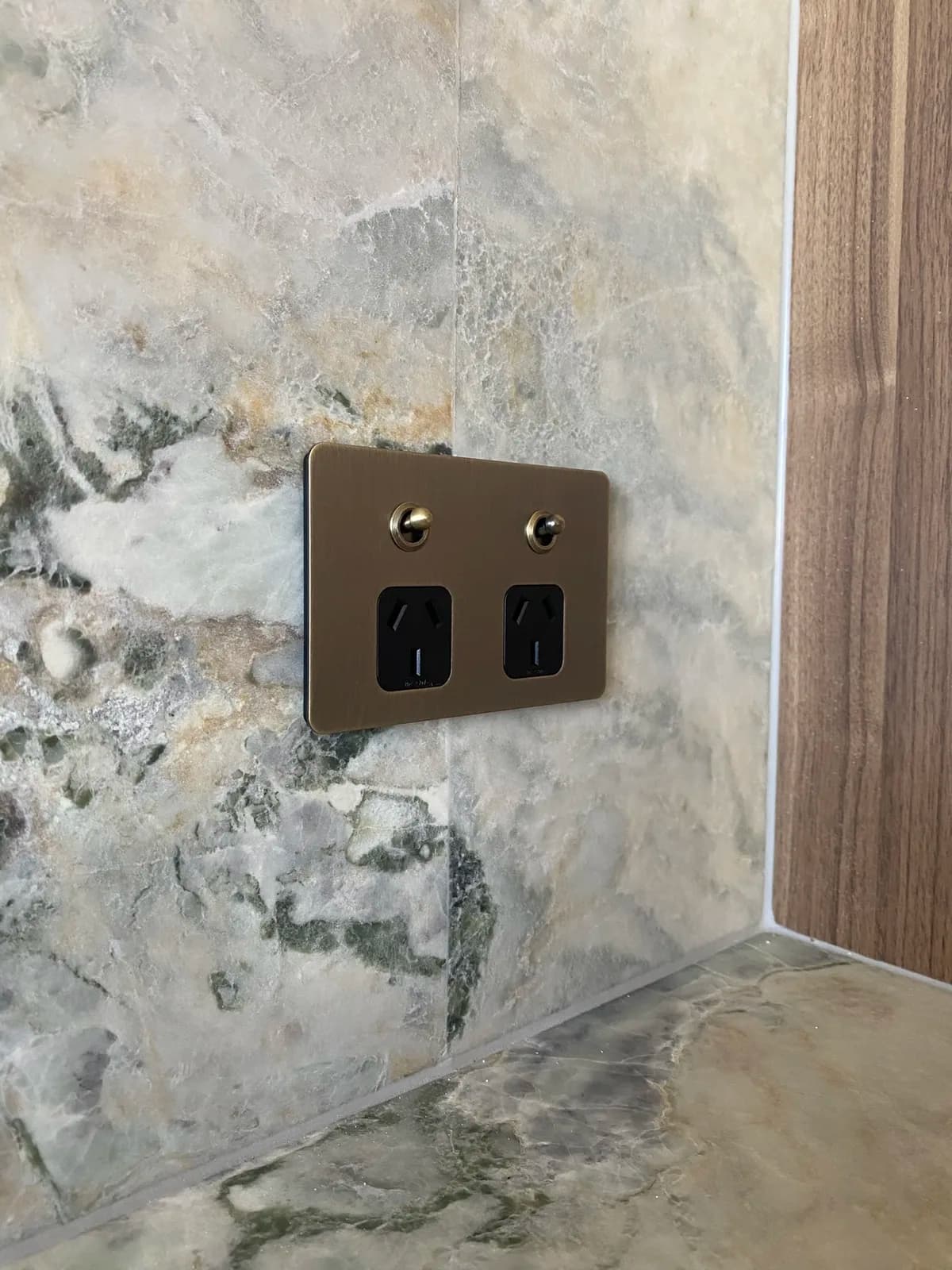 Brass double powerpoint fitted flush into a marble splashback