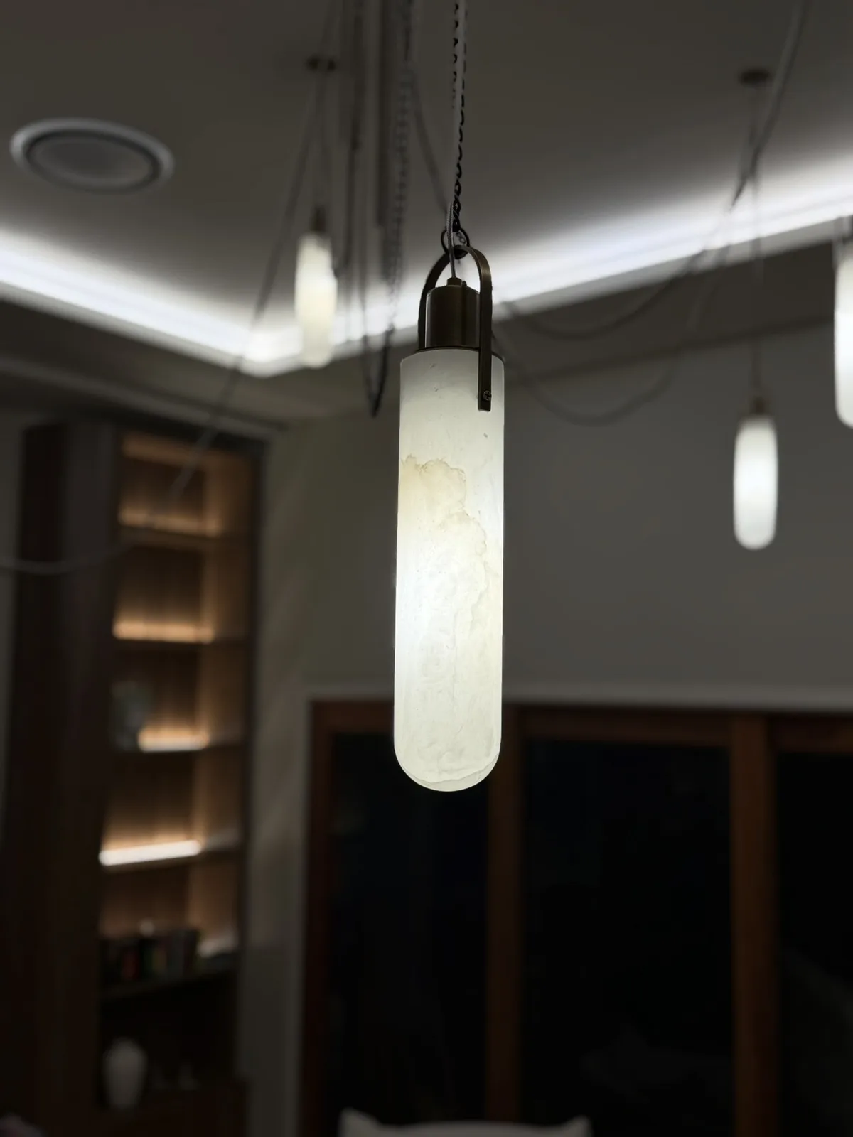 Feature pendants and cove lighting in a living room