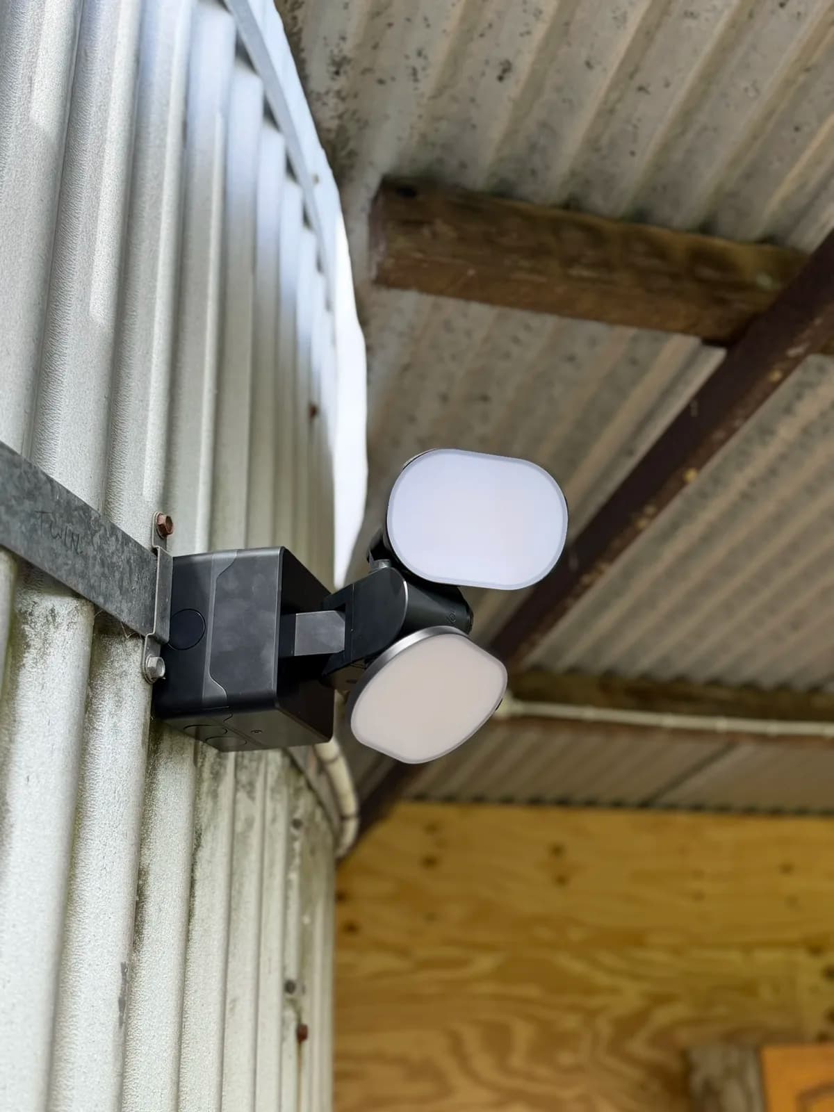 Twin LED flood light mounted under a roof