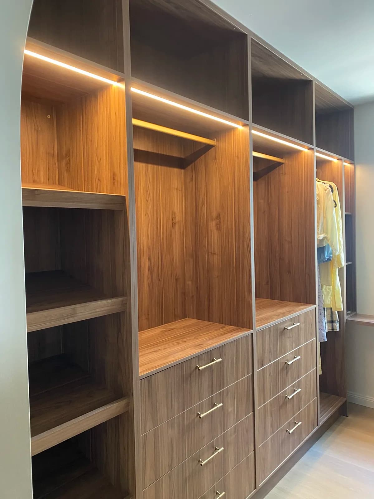 Walk-in wardrobe with LED strip lighting in the shelving